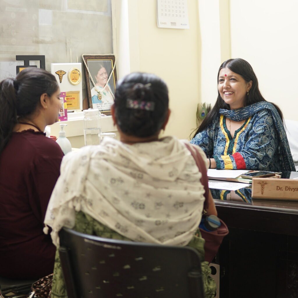 Dr. (Mrs.) Divya Batra, M.B.B.S. (Gold Medalist), D.G.O. (Mumbai), consulting with patients in her gynecology clinic at Anantshree Hospital.