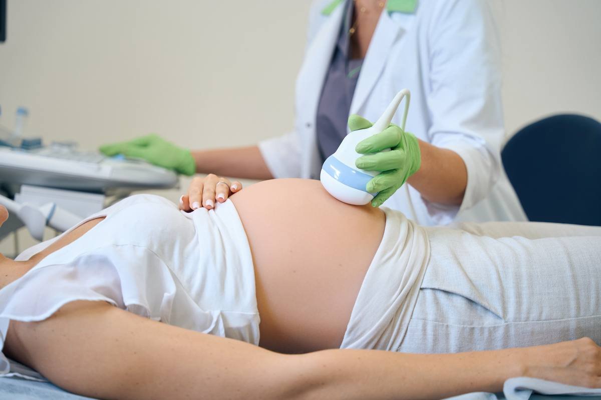 Pregnant woman receiving an ultrasound examination as part of maternity and antenatal care.