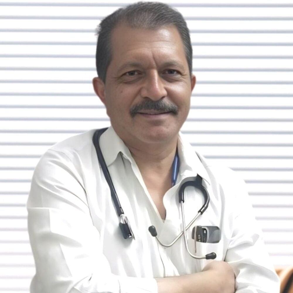 Portrait of Dr. R. John, MS General Surgeon, wearing a white coat and stethoscope.